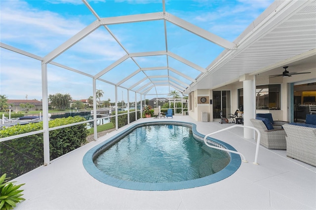 view of swimming pool with glass enclosure and a patio