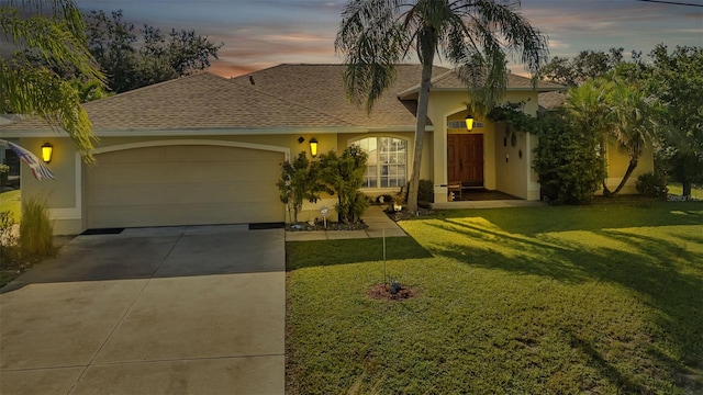 mediterranean / spanish home featuring a lawn and a garage