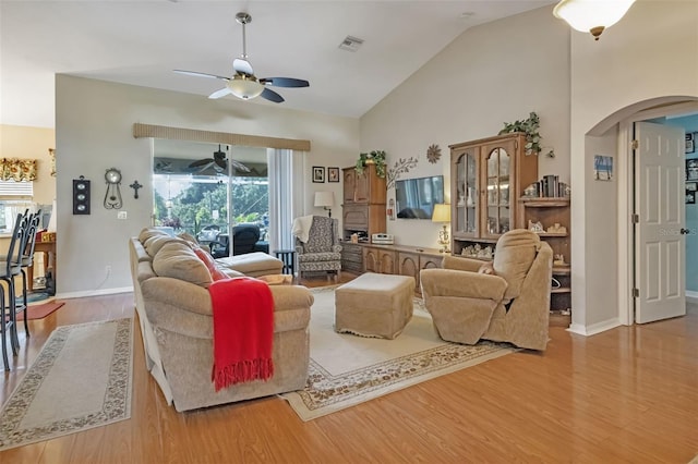 living room featuring light hardwood / wood-style flooring, ceiling fan, and a healthy amount of sunlight