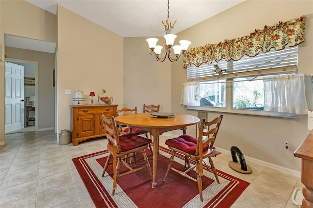 tiled dining room with an inviting chandelier