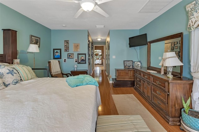 bedroom with ceiling fan and hardwood / wood-style floors