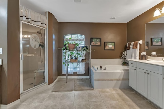 bathroom with tile patterned floors, shower with separate bathtub, and vanity