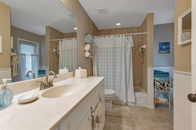 full bathroom with tile patterned flooring, vanity, toilet, and shower / bath combo with shower curtain