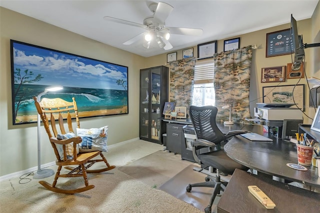 carpeted home office featuring ceiling fan