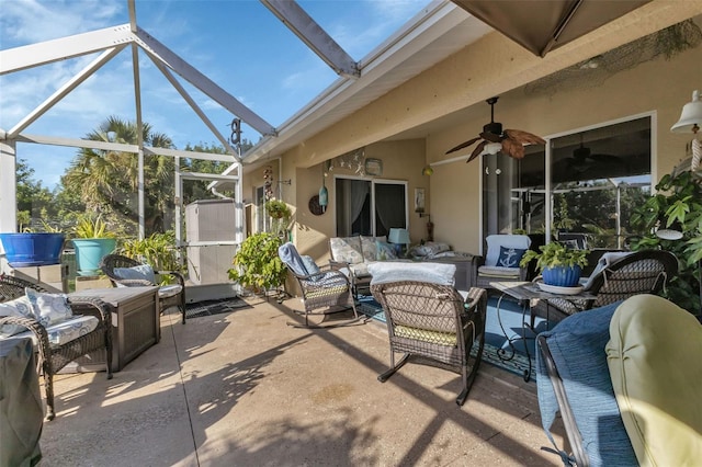 view of patio / terrace featuring outdoor lounge area, ceiling fan, and a lanai