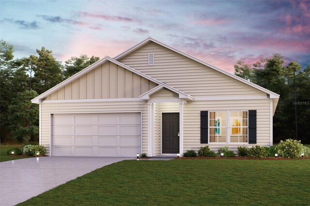 view of front of home featuring a garage and a yard