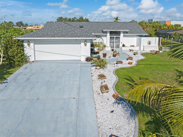 ranch-style house featuring a garage and a front lawn