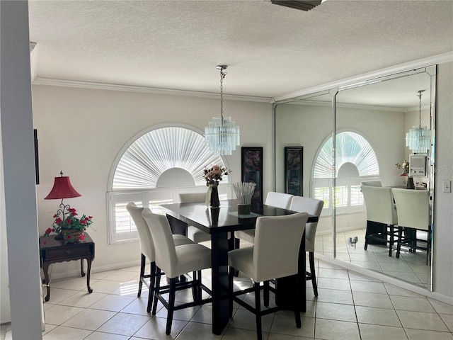 tiled dining room featuring crown molding, a textured ceiling, and a notable chandelier