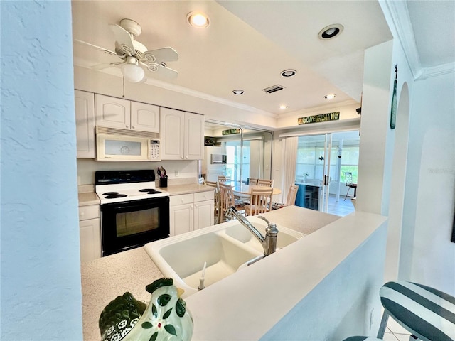 kitchen featuring white cabinetry, white appliances, and a healthy amount of sunlight