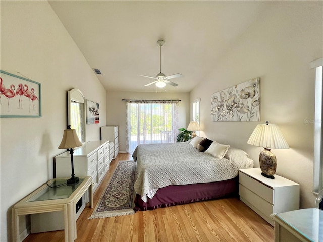 bedroom with ceiling fan, vaulted ceiling, and light hardwood / wood-style floors