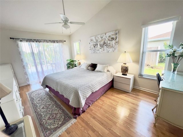 bedroom with light hardwood / wood-style flooring, multiple windows, ceiling fan, and vaulted ceiling