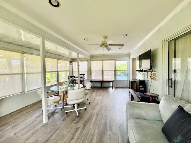 sunroom / solarium featuring ceiling fan