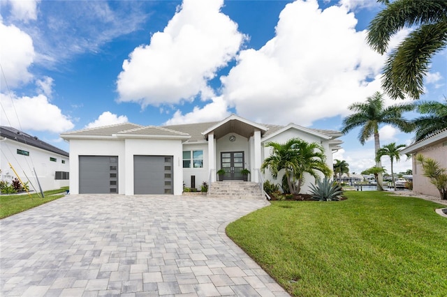 view of front of home featuring a garage and a front yard