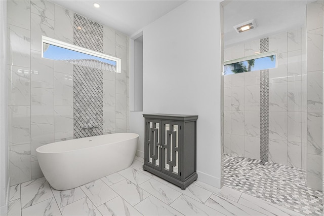 bathroom with tile walls, a healthy amount of sunlight, and separate shower and tub