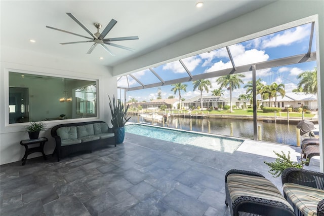 view of pool featuring a lanai, a patio area, ceiling fan, and a water view