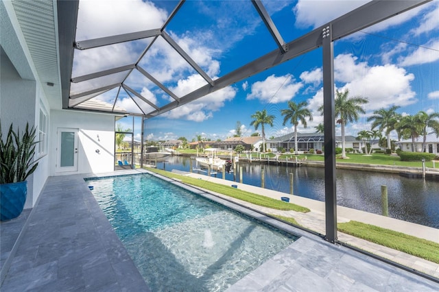 view of pool with a lanai, a water view, and a patio area