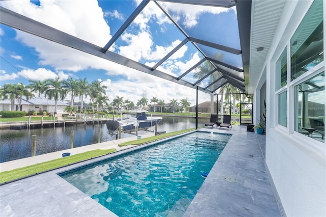 view of swimming pool featuring a lanai, a water view, and a patio area