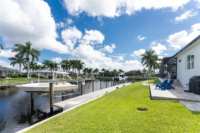 view of dock with glass enclosure, a water view, and a lawn