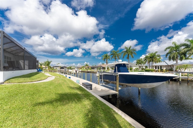 dock area featuring a water view, a yard, and glass enclosure