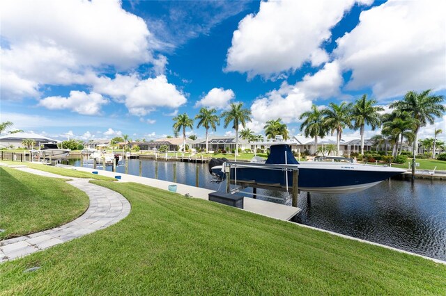 view of dock featuring a yard and a water view