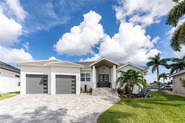 view of front of property featuring a garage and a front yard