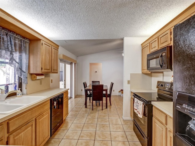 kitchen with sink, black appliances, light tile patterned floors, light brown cabinets, and lofted ceiling