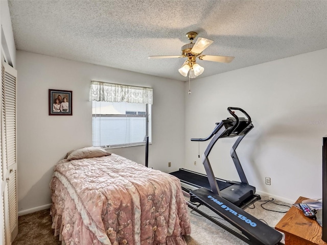 carpeted bedroom featuring a textured ceiling, a closet, and ceiling fan