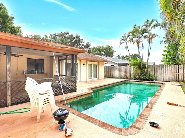 view of swimming pool with ceiling fan and a patio area