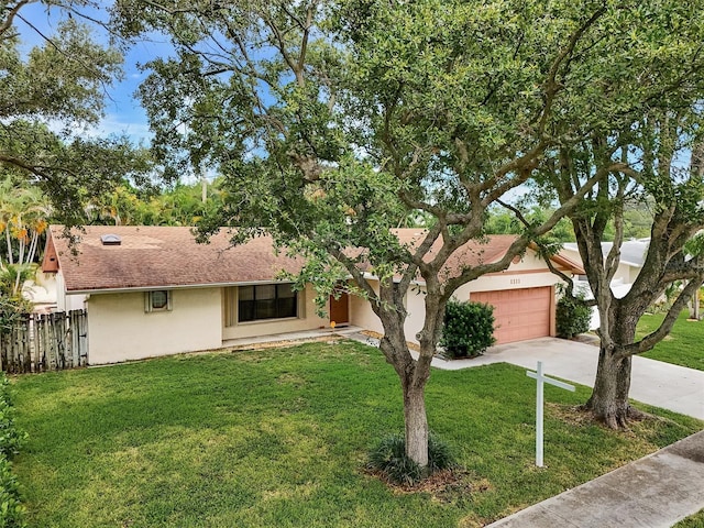 single story home featuring a front yard and a garage