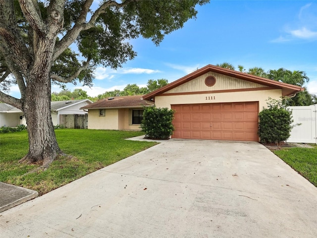 ranch-style home featuring a front lawn and a garage