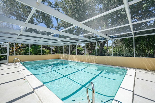 view of swimming pool with a lanai and a patio area