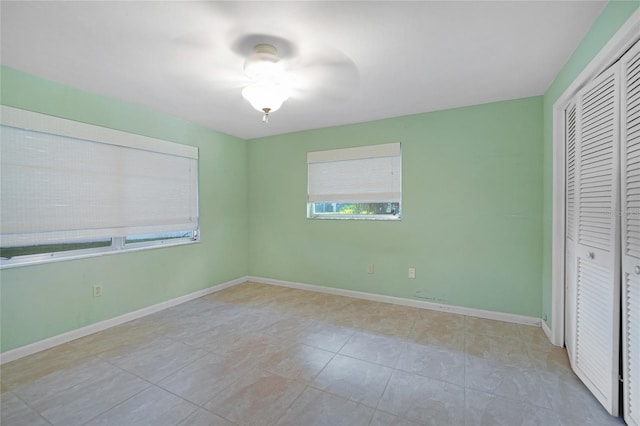 unfurnished bedroom featuring baseboards and a closet