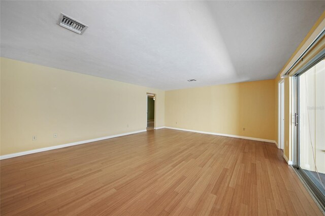 empty room with light hardwood / wood-style flooring