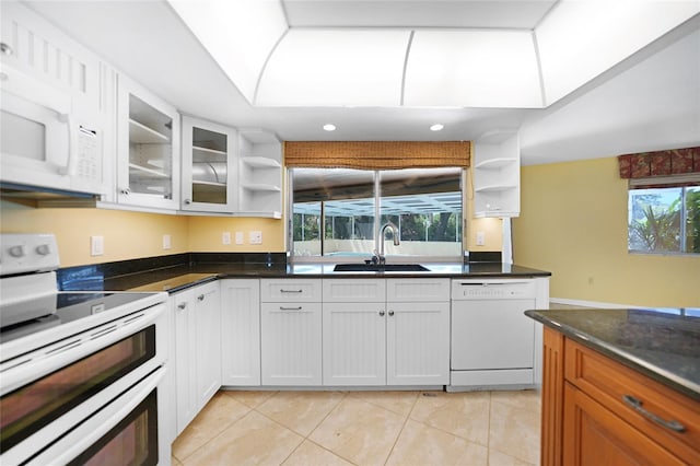 kitchen featuring white appliances, white cabinetry, open shelves, and a sink