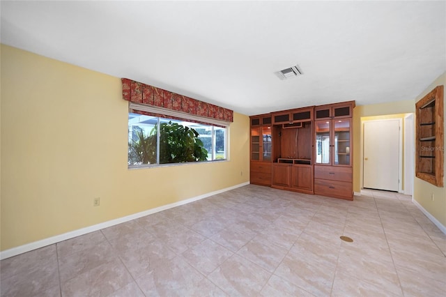 interior space with baseboards and visible vents