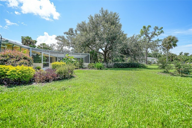 view of yard with a lanai