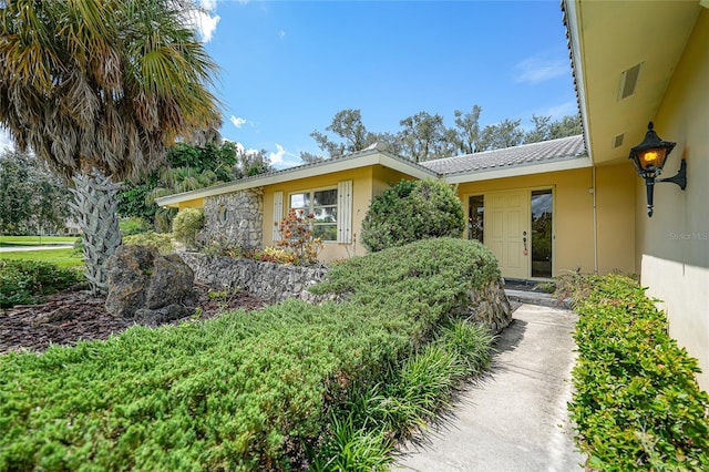 property entrance featuring stucco siding