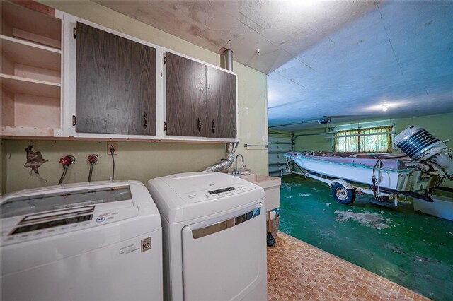 laundry area featuring washer and dryer and cabinets