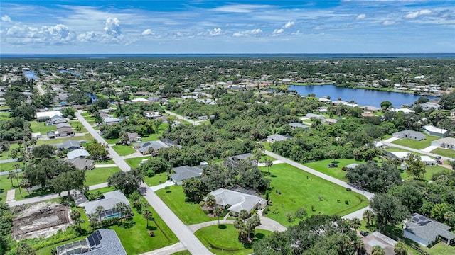 birds eye view of property with a water view and a residential view