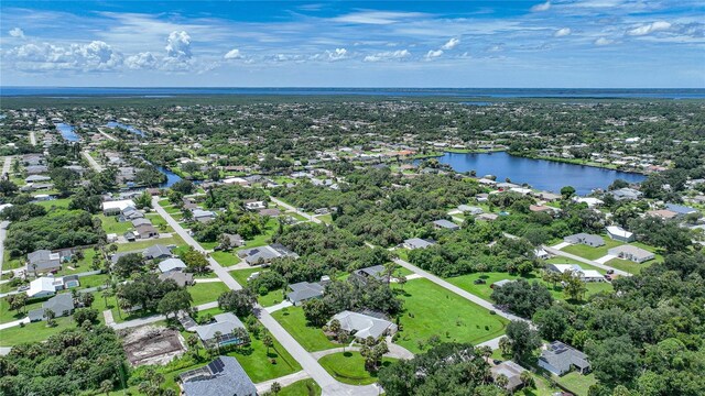 drone / aerial view with a water view and a residential view