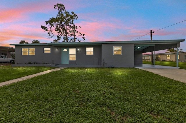 single story home with a yard and a carport