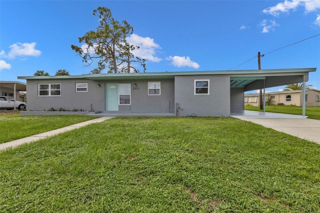 ranch-style home with a carport and a front lawn