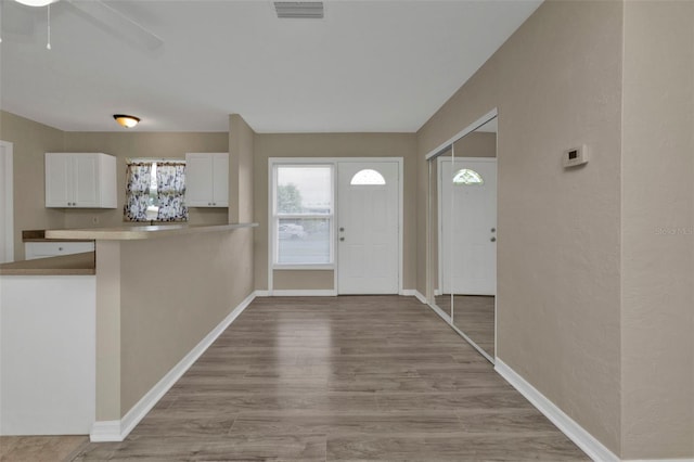 entryway with ceiling fan and light wood-type flooring