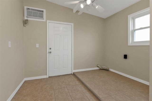 interior space with ceiling fan and a wall unit AC