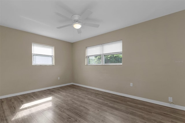 empty room with ceiling fan and hardwood / wood-style floors