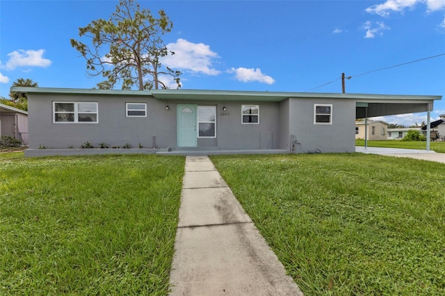 single story home with a front yard and a carport