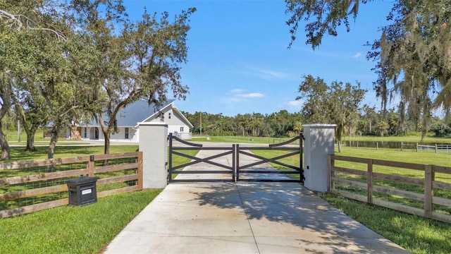 view of gate featuring a lawn