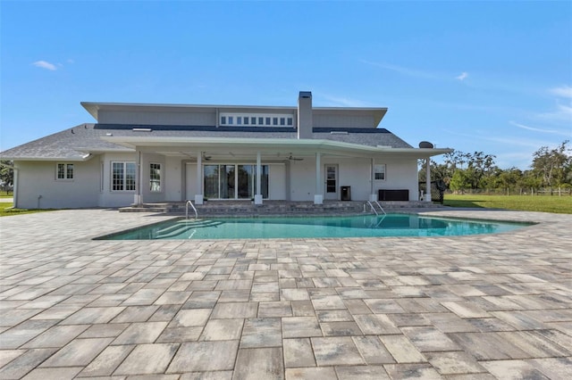 rear view of house featuring ceiling fan and a patio area