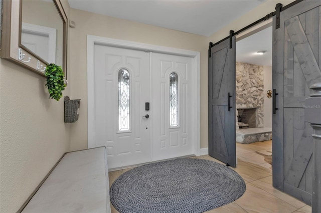 tiled entrance foyer with a barn door