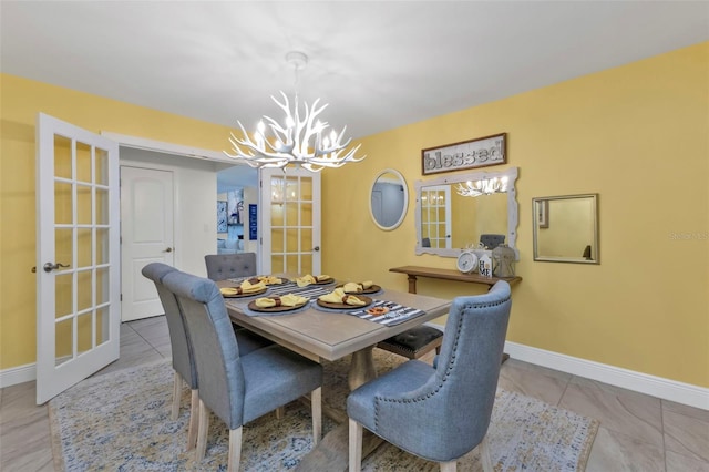 tiled dining space featuring french doors and a notable chandelier